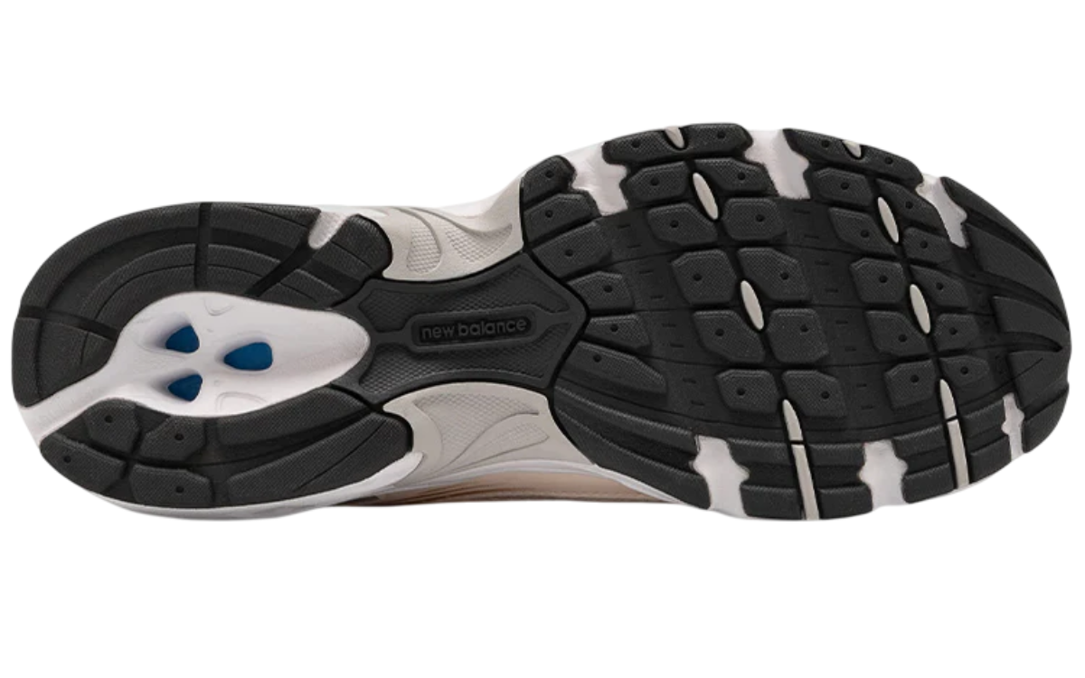 Close-up of a running shoe sole with tread pattern on a white background