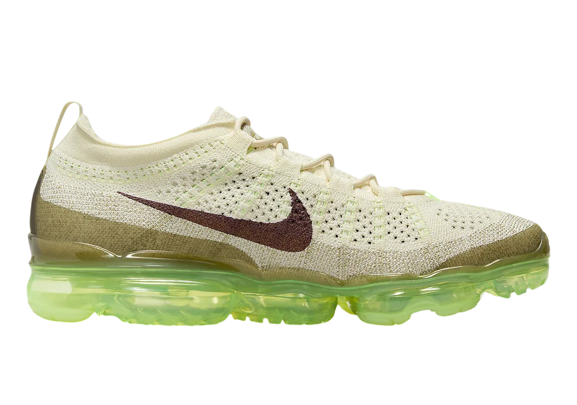 Side view of Nike Air Vapormax 2023 Flyknit Volt shoes showing transparent Air sole and sleek Flyknit upper.