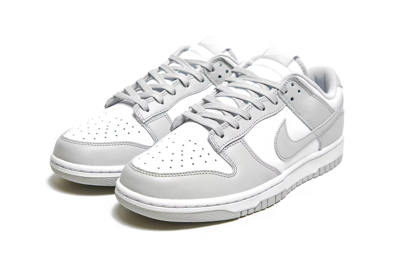Nike Dunk Low Retro White Grey Fog shoes highlighting swoosh design and classic silhouette.